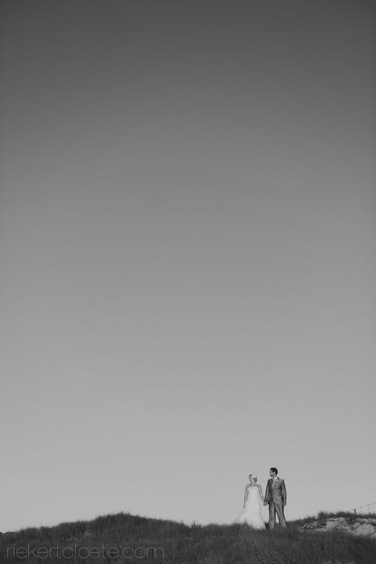 wedding couple atop a hill