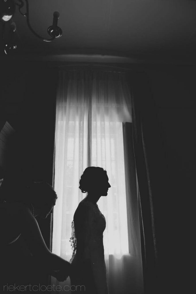 Silhouette of bride at a window