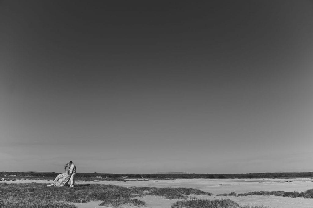 Weddind couple on grassy beach
