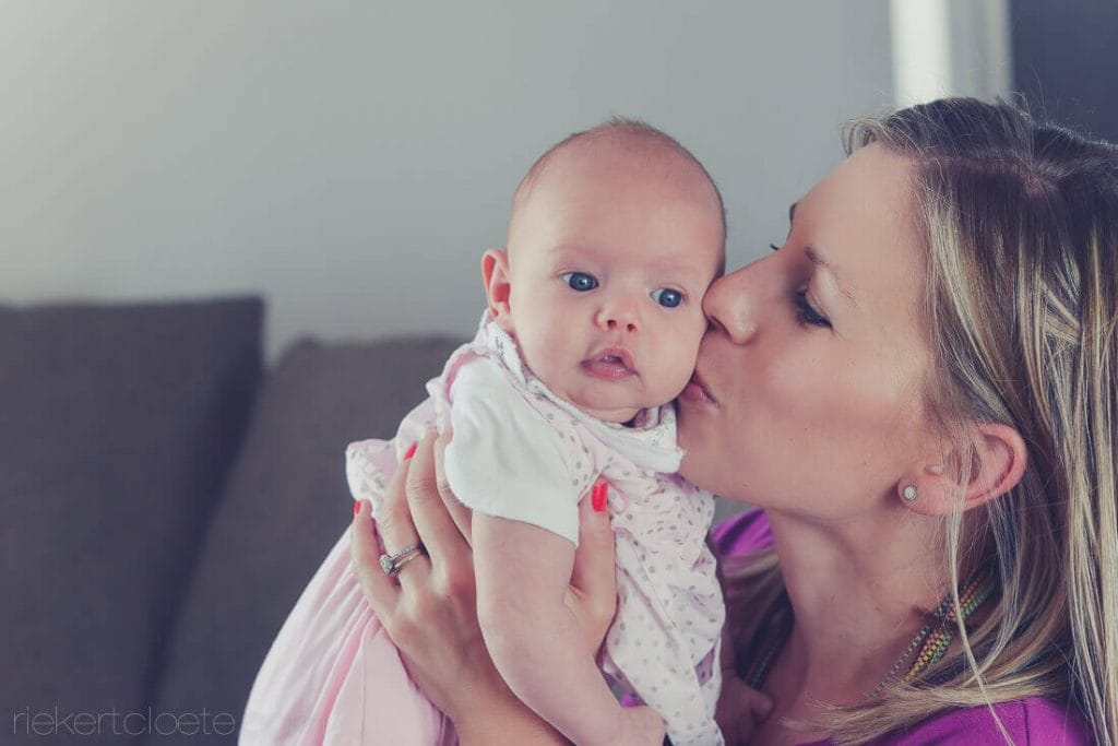 Mom kissing baby