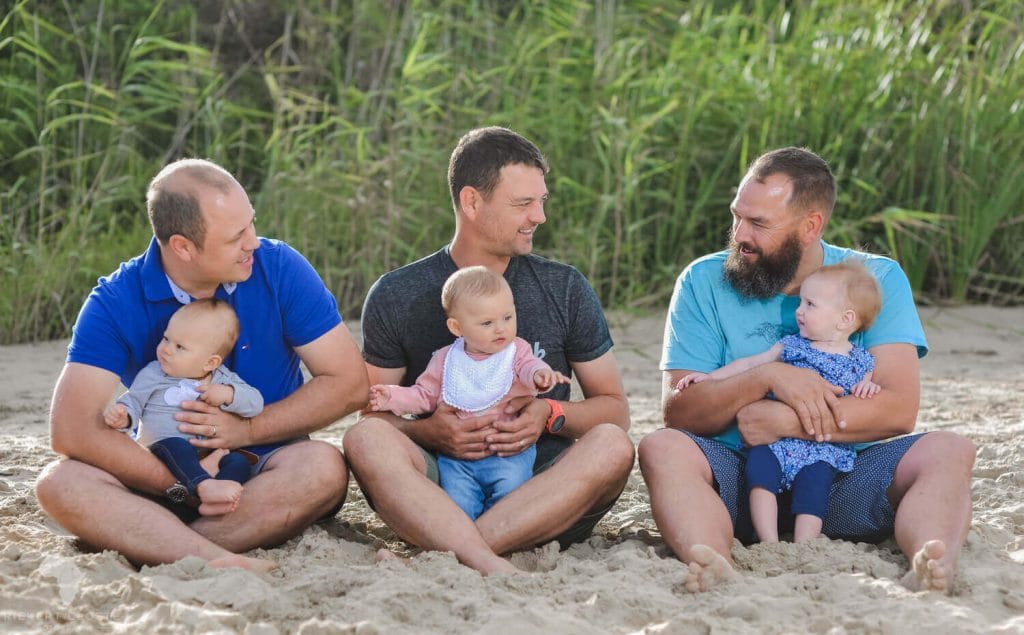 Dads sitting on beach