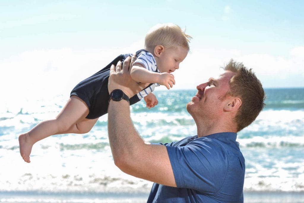 Dad and kid on beach