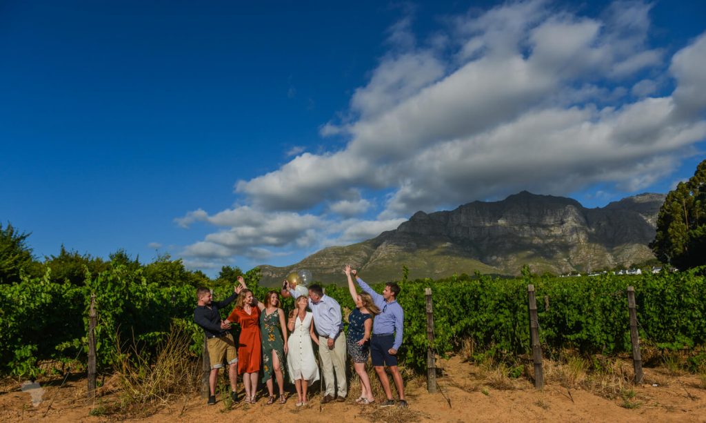 Family standing in vineyards