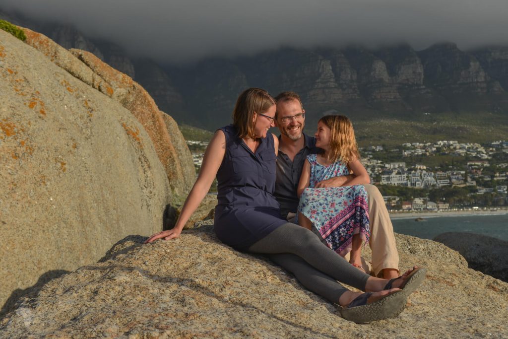 Family sitting on rock