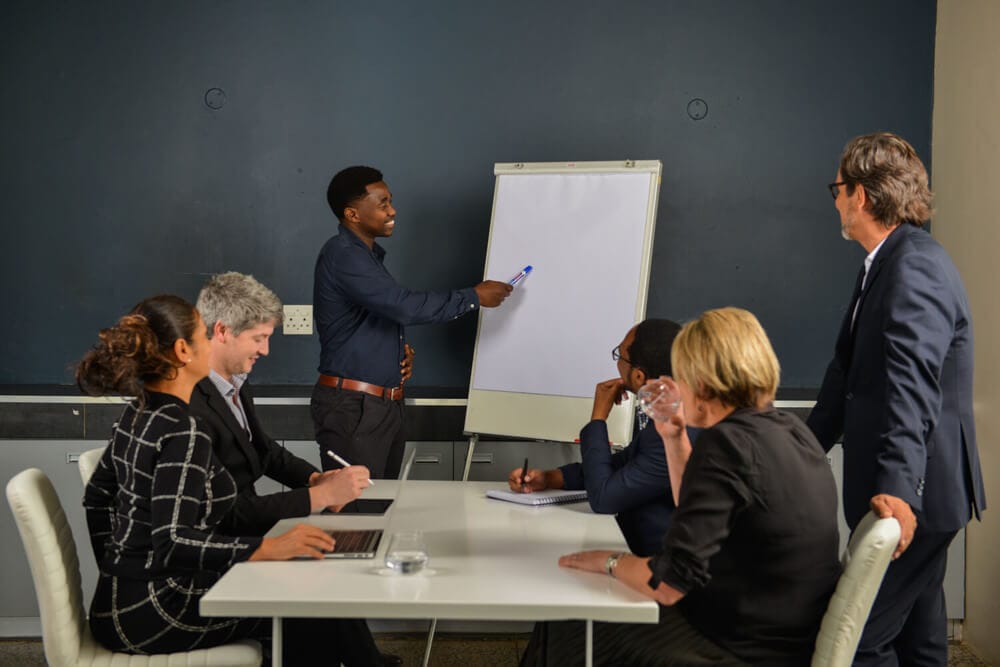 Staff looking at white board