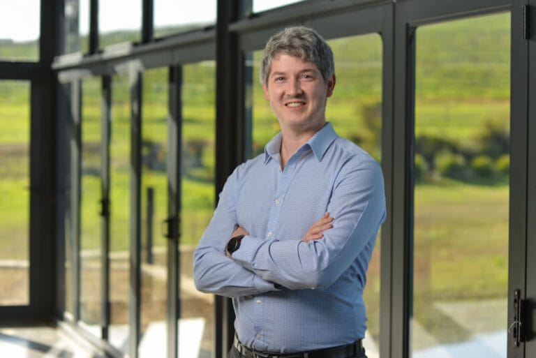 Man folding arms wiith blue shirt