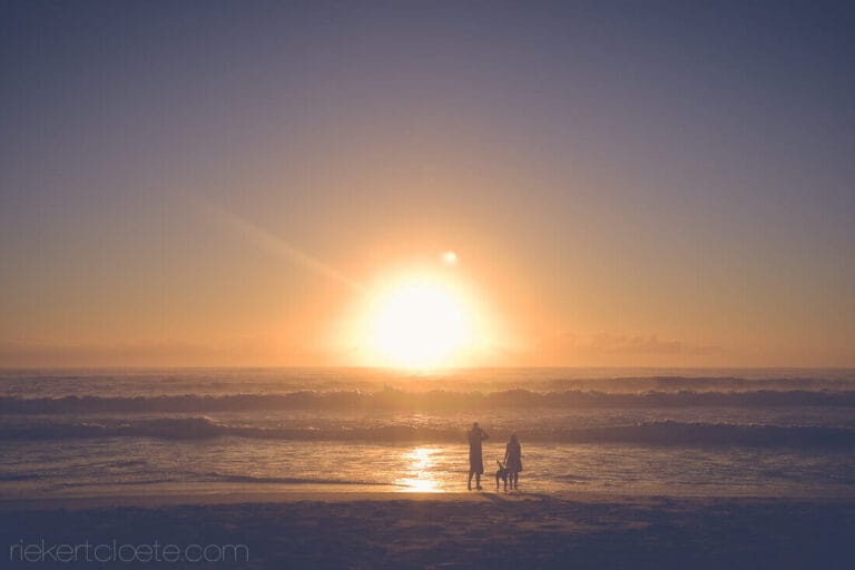 Wide shot of beach with a family on it