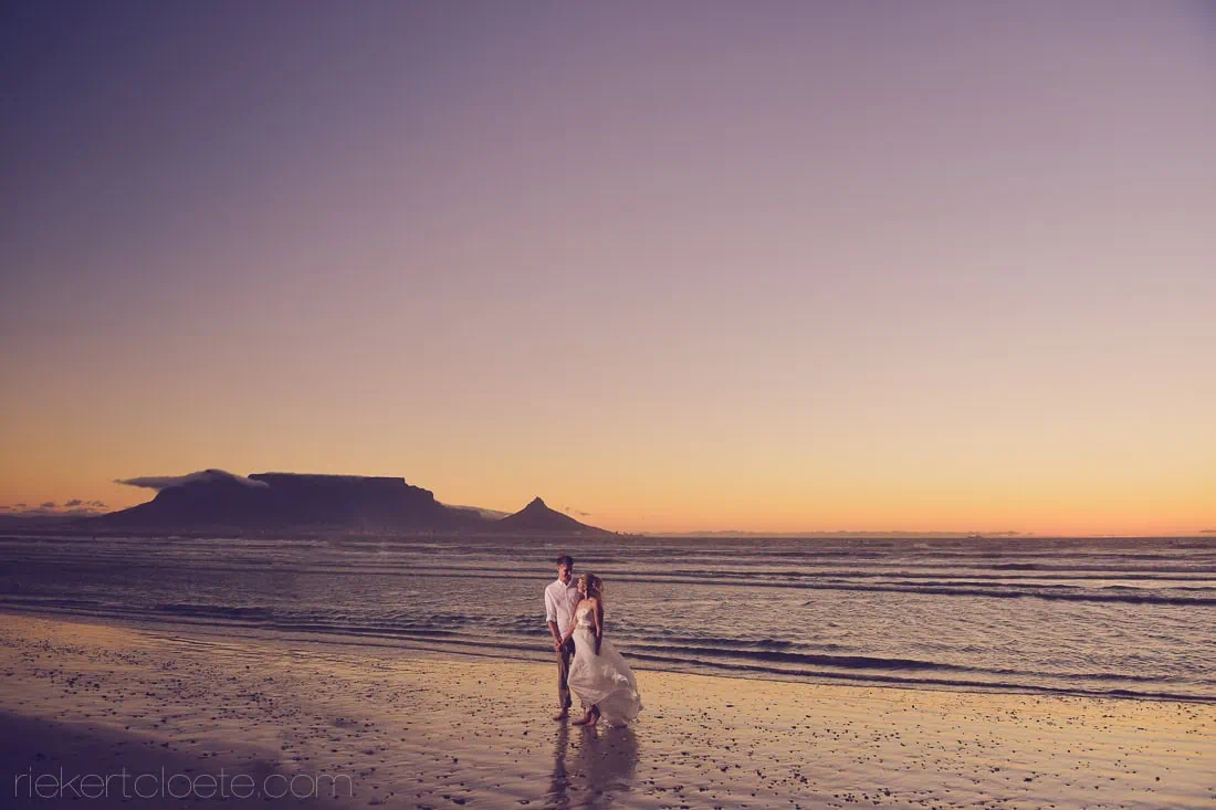 couple beach walk table mountain purple dusk