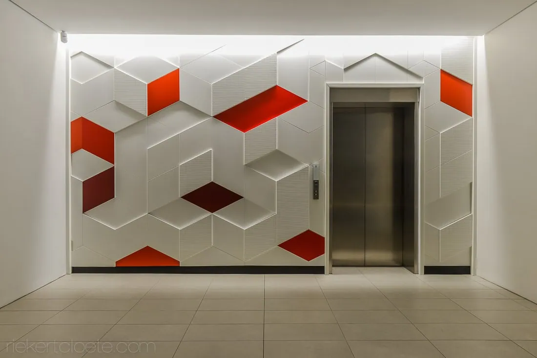 geometric red panel entry hall elevator commercial interior photography durbanville
