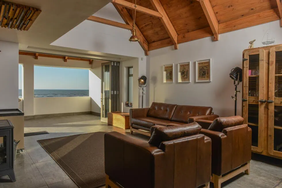 modern lounge leather seating timber beams sea view interior photography franschhoek
