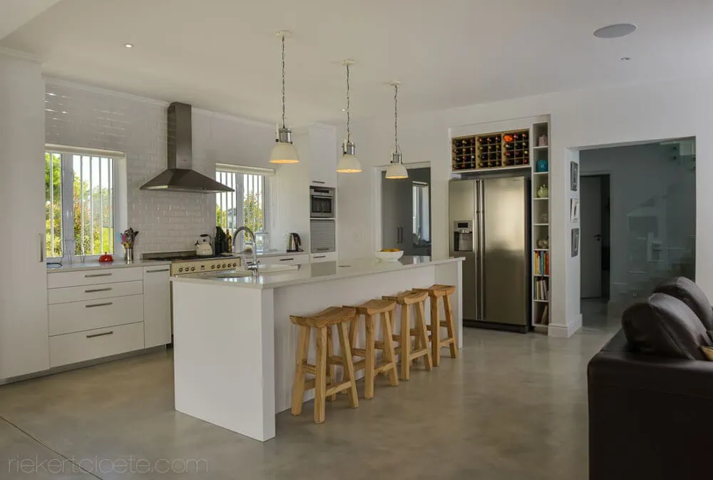 modern open plan kitchen white cabinetry bar stools interior photography western cape