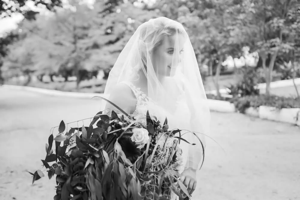 Allesverloren bride walking veil greenery bouquet tree lined path