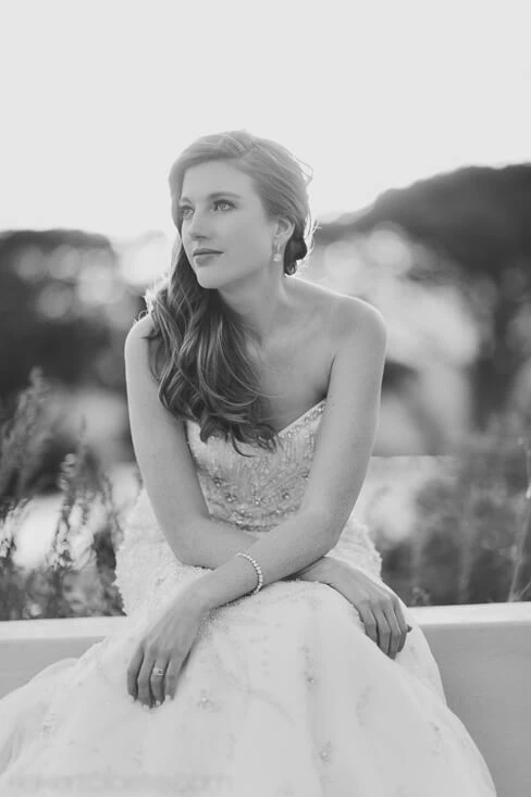 Cape Point Vineyards bride beaded gown sitting outdoor ledge portrait