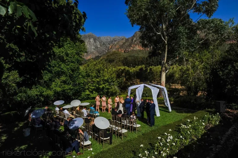 Misty outdoor ceremony mountain backdrop draped arch western cape