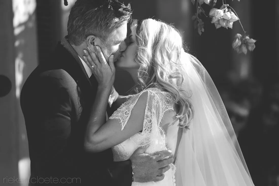 Saronsberg bride groom first kiss outdoor floral arch
