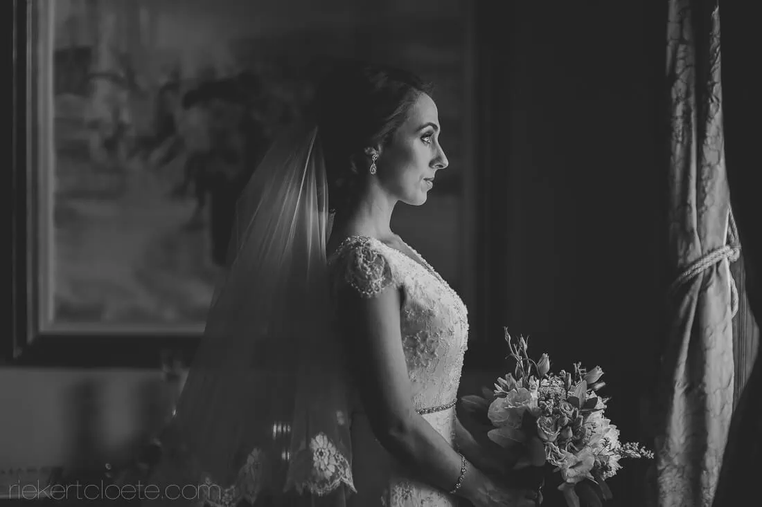 Steenberg bride profile waiting window lace gown floral bouquet