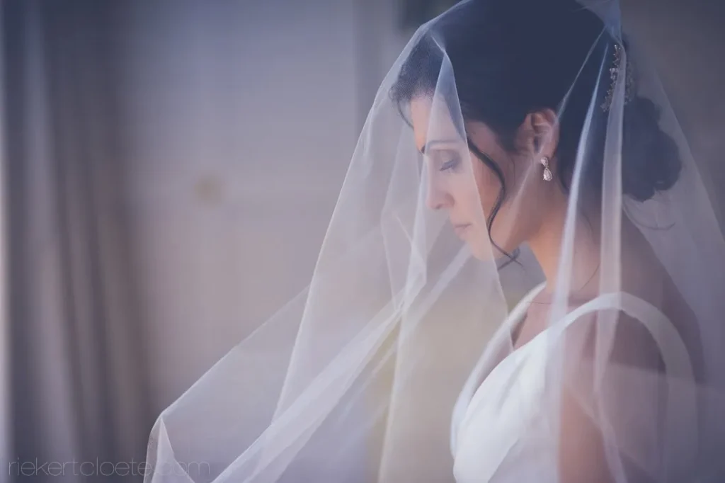 Tokara bride profile veil draped elegant updo portrait