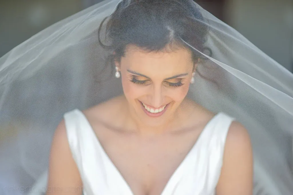 Tokara bride smiling veil vneck satin gown outdoor light