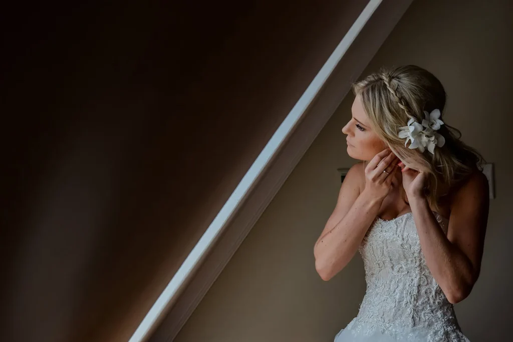 Vrede and Lust bride earring floral hair piece diagonal window light