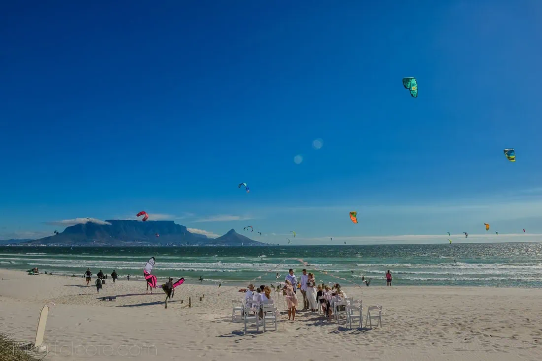 beach ceremony table mountain view kite surfers blouberg