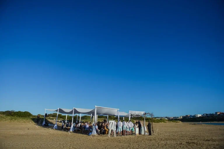beach ceremony white canopy sandy dunes coastal town