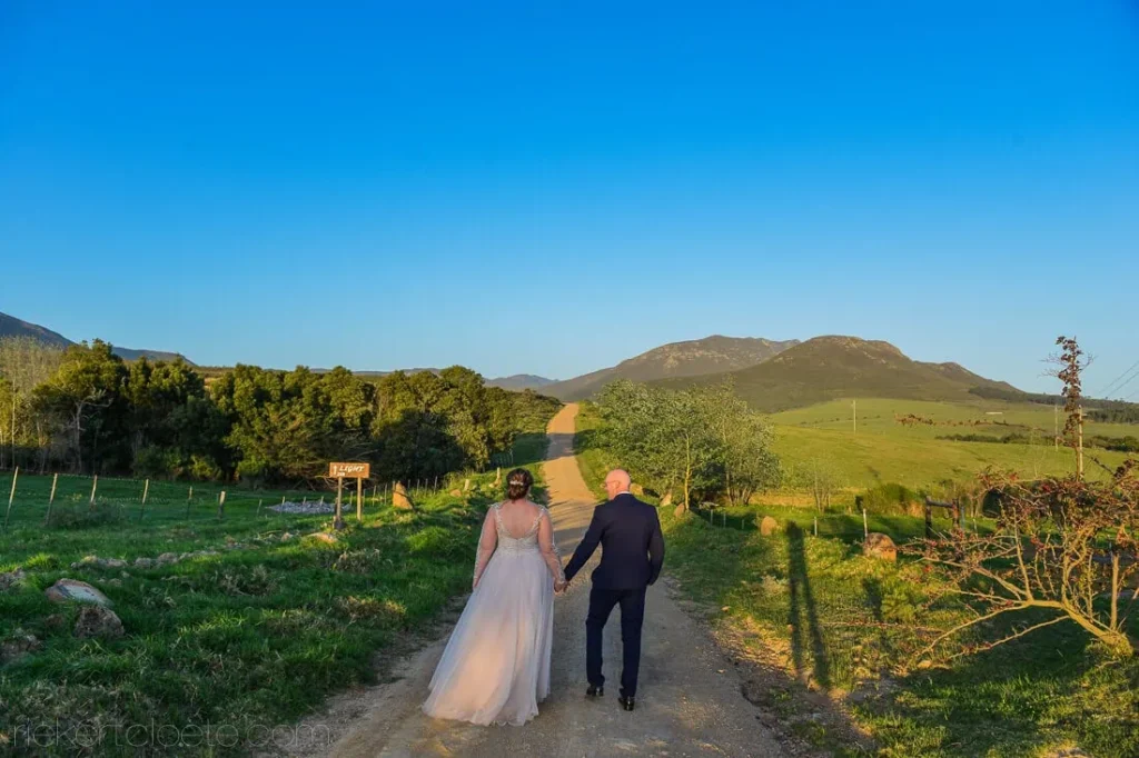 beloftebos couple walking dirt road mountain view