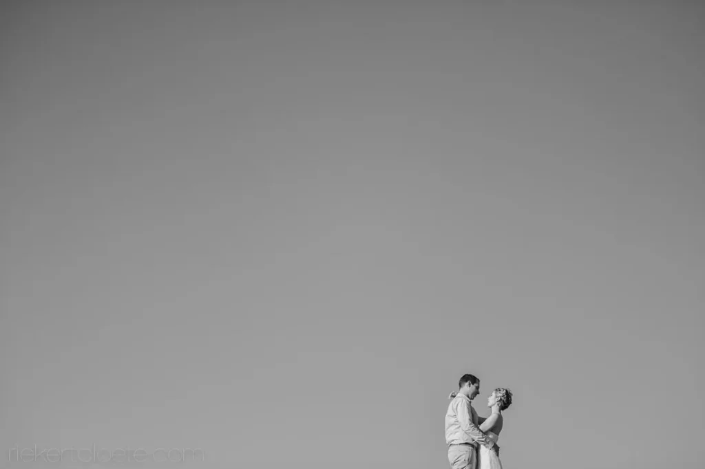 black white couple embracing clear sky minimalist