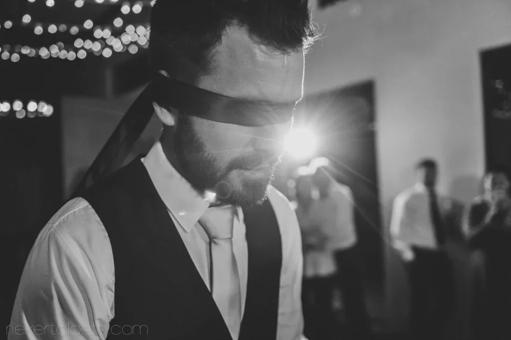 blindfolded groom garter toss reception game