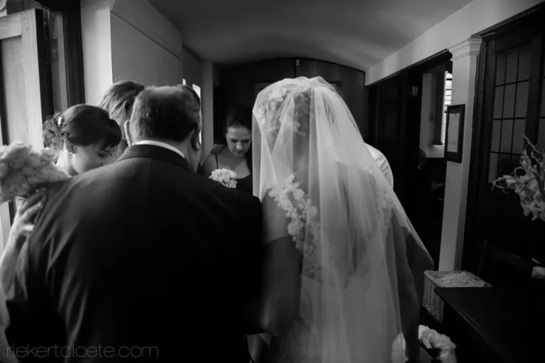 bridal party prayer indoors before ceremony