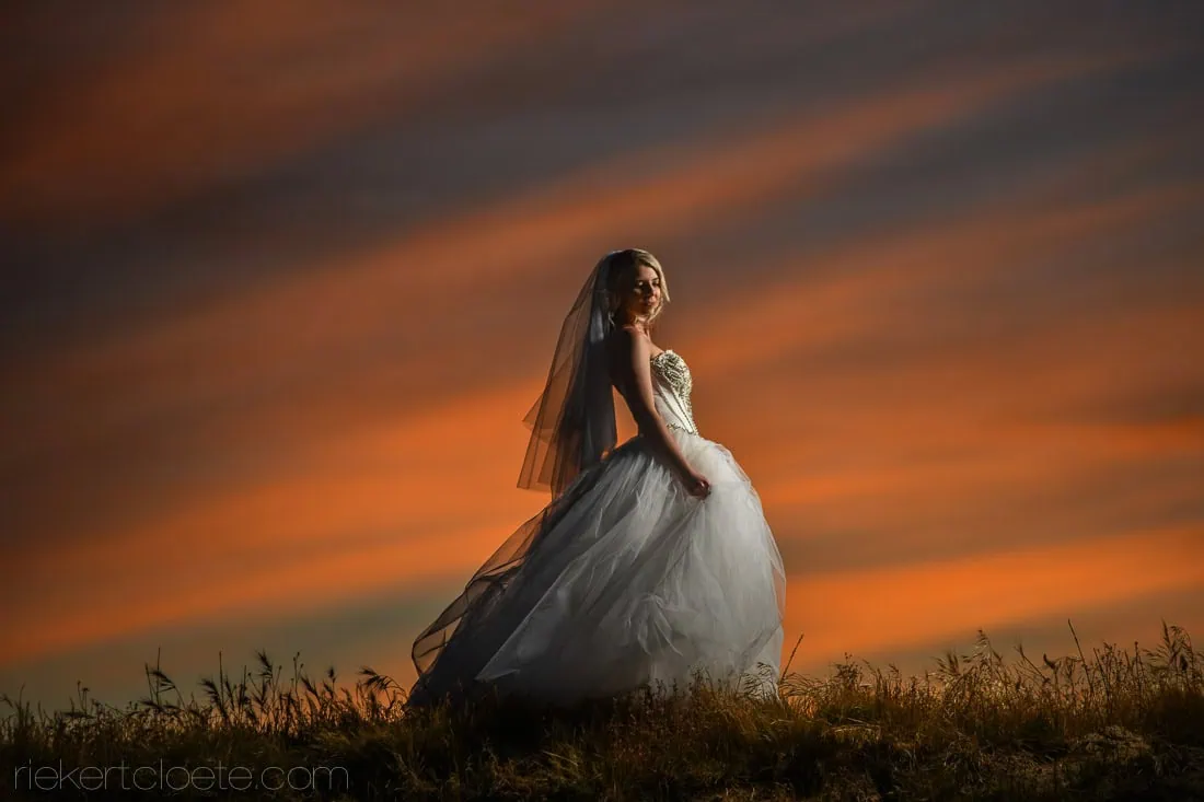 bride ballgown veil dramatic orange sunset