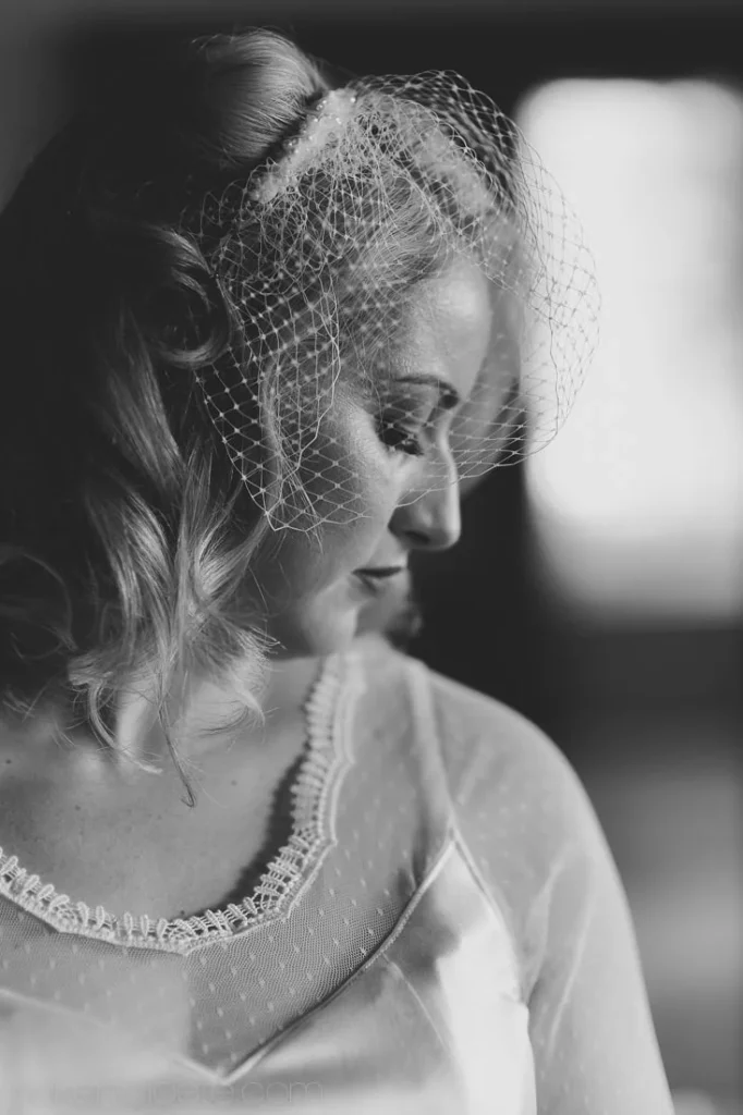 bride birdcage veil pearl necklace profile portrait