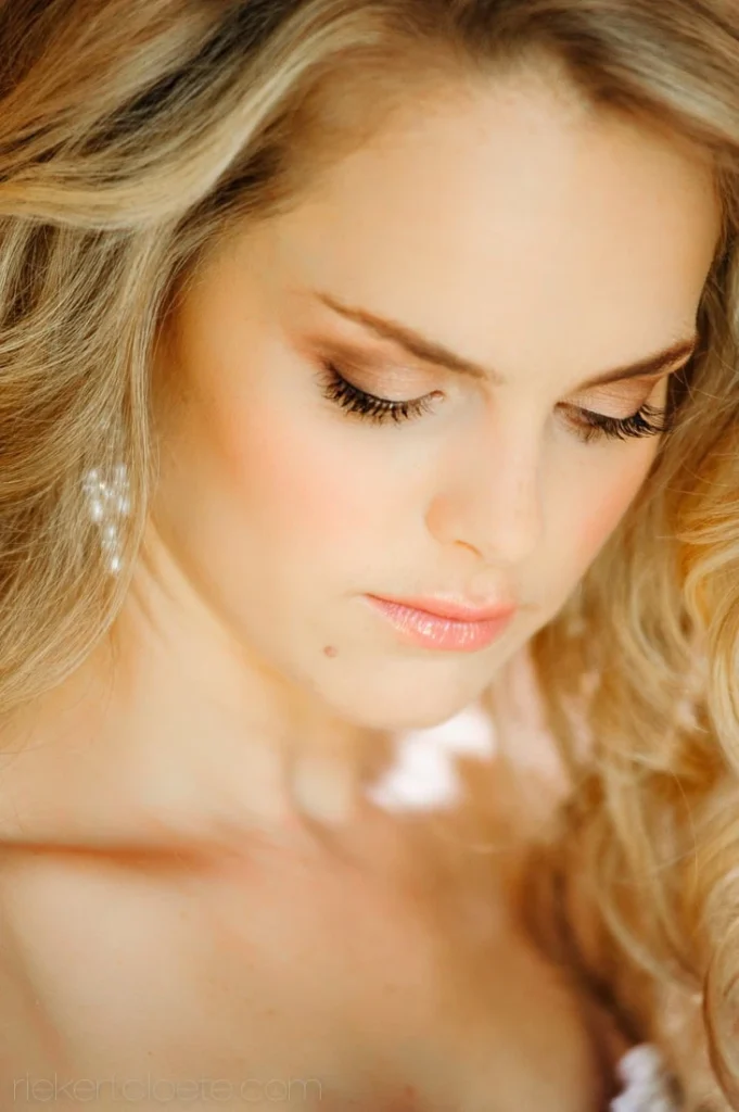 bride blonde soft curls pearl earrings looking down