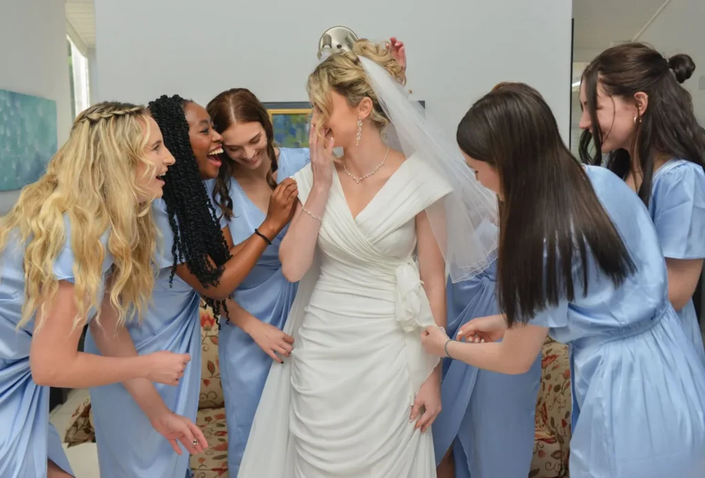 bride bridesmaids blue dresses excited reaction getting ready