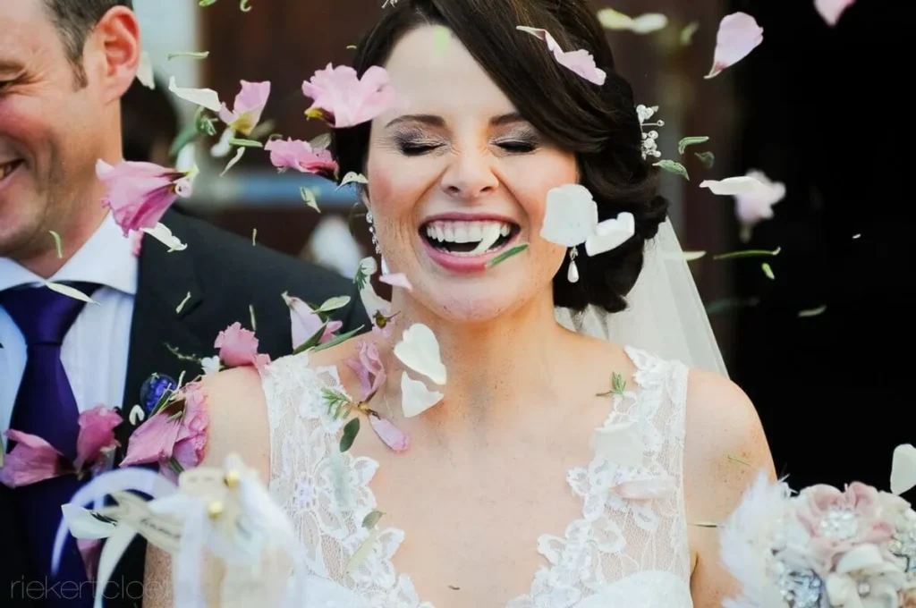 bride close up laughing pink flower petals