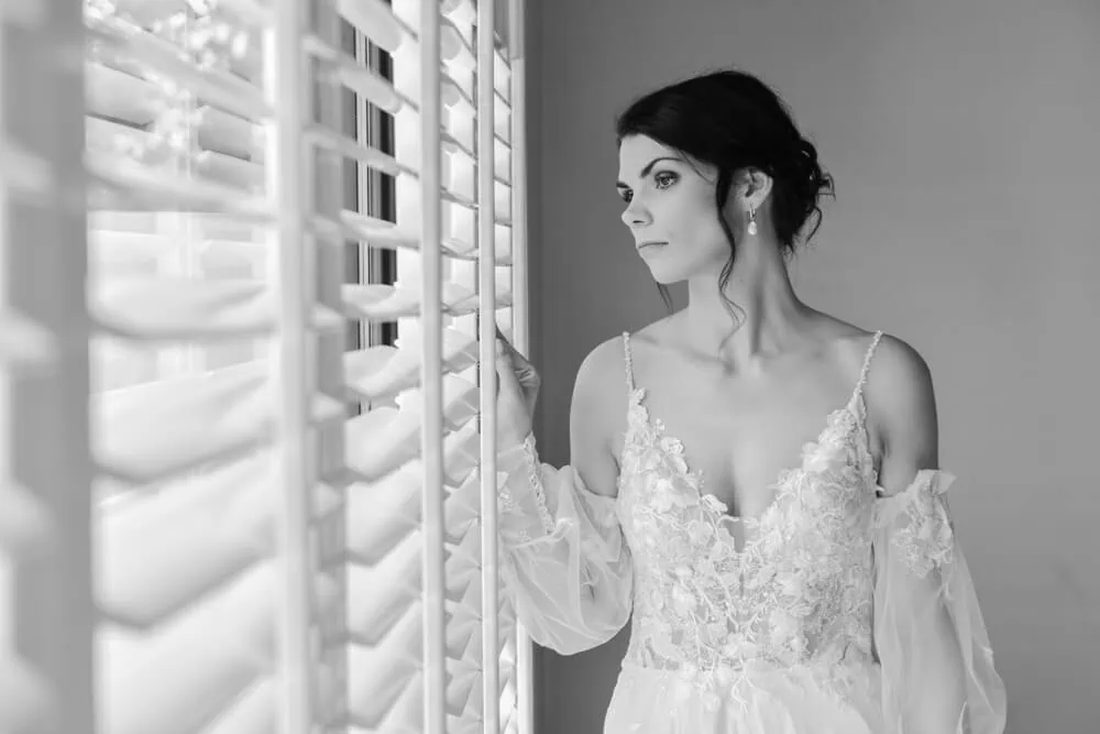 bride floral lace cold shoulder gown window light