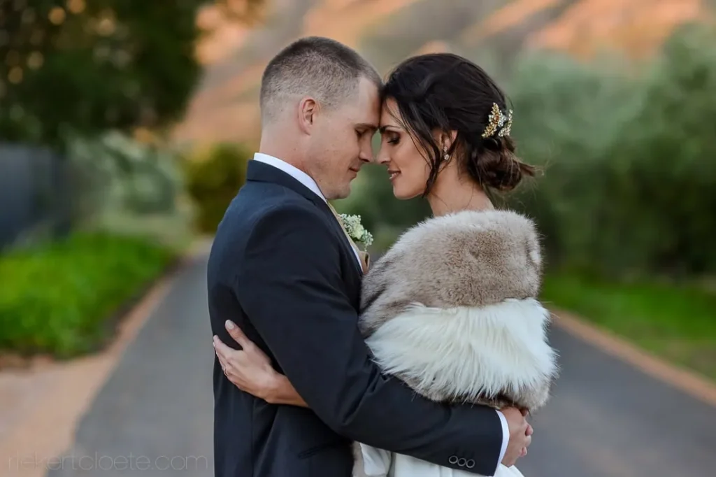 bride fur stole groom forehead touch winelands road