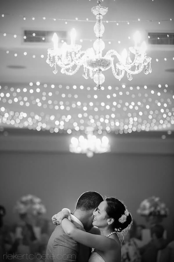 bride groom dancing asara chandelier bokeh lights