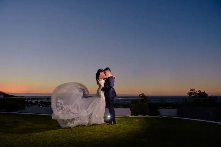 bride groom embrace rooftop ocean sunset view