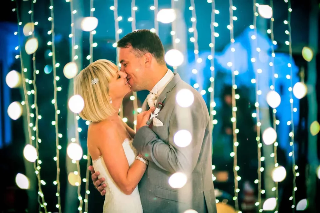 bride groom first dance kiss fairy lights