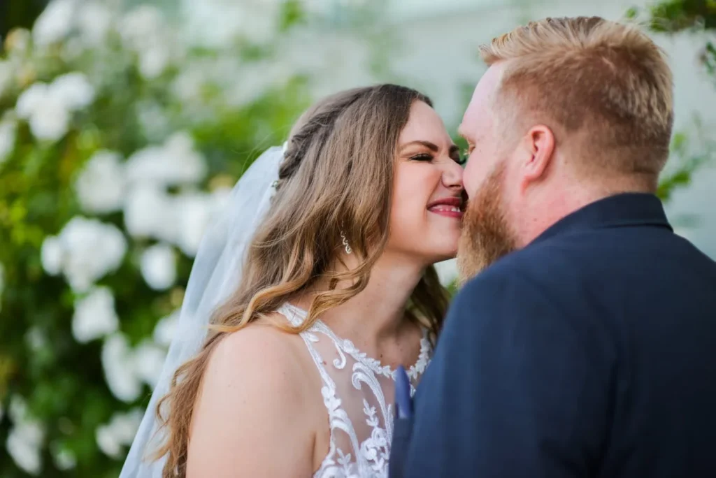 bride groom floral arch lace gown joyful moment