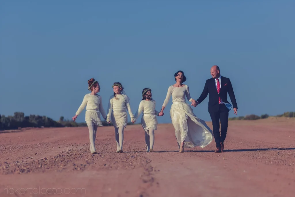 bride groom flower girls red desert dirt road
