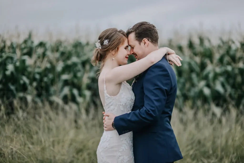 bride groom forehead to forehead maize field moody