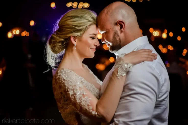 bride groom foreheads touching lace sleeve gown