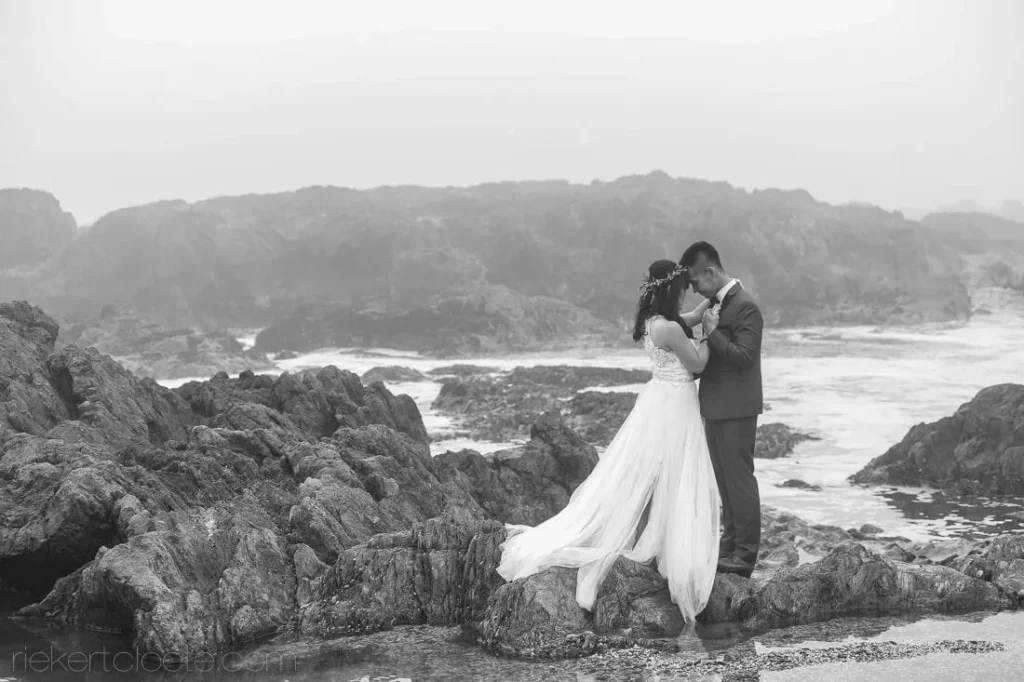 bride groom kissing rocky coastline waves