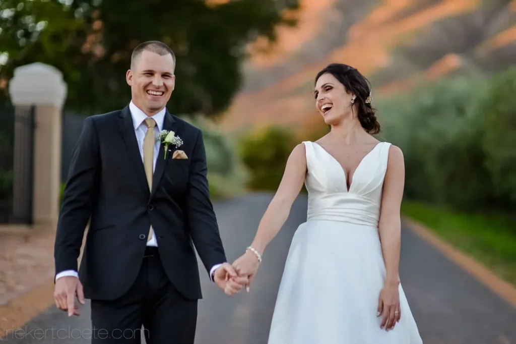 bride groom laughing walking mountain road