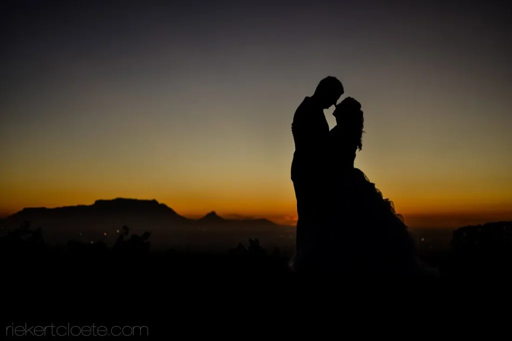 bride groom silhouette kiss table mountain sunset