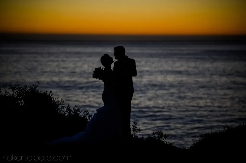 bride groom silhouette ocean cliff sunset