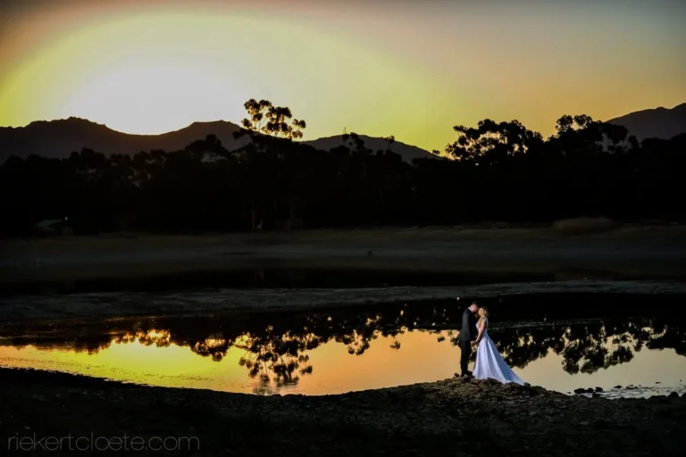 bride groom sunset dam reflection silhouette mountains