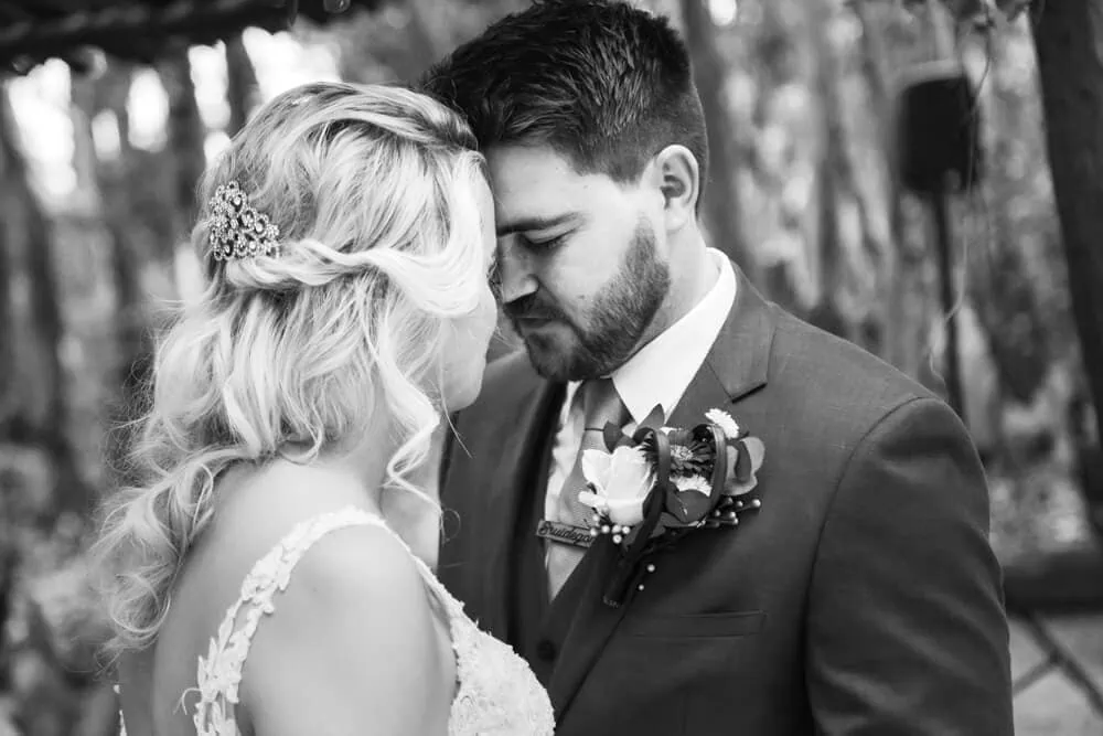 bride groom touching foreheads forest portrait
