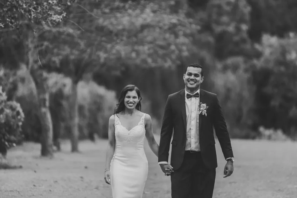 bride groom walking tree lined garden portrait